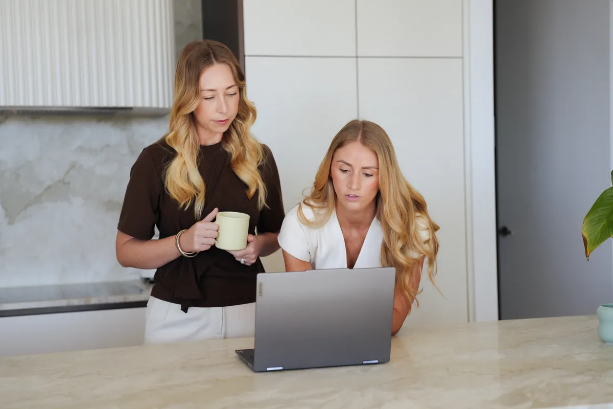 Lauren Jones, director of Yield Street Property Buyers, working at a laptop at a kitchen bench
