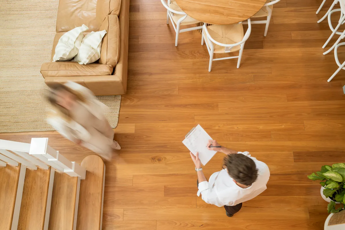 Overhead view of a property inspection, with notes being taken on a clipboard